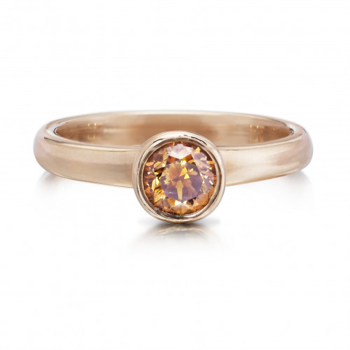 One natural fancy orange brown round brilliant cut diamond, 5.7 mm, .71 carats 14 karat rose gold band, width 2.8 mm, high polish. To buy this product please visit here https://eyeonjewels.com/product/orange-brown-brilliant-cut-diamond-ring-14195