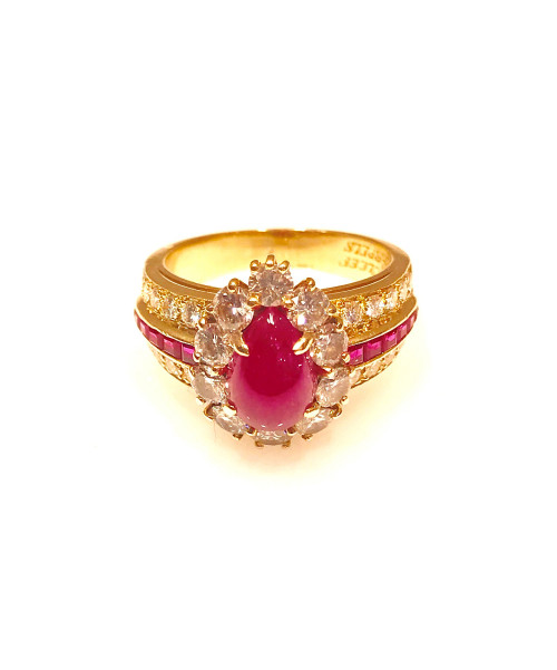 A Van Cleef & Arpels pear shape cabochon ruby and diamond 18 karat yellow gold ring. The cabochon ruby is prong set and surrounded by ten round brilliant diamonds, atop a three row half shank containing two rows of diamonds and a row of rubies. To buy this product please visit here https://eyeonjewels.com/product/van-cleef-arpels-cabochon-ruby-and-diamond-yellow-gold-ring-14059